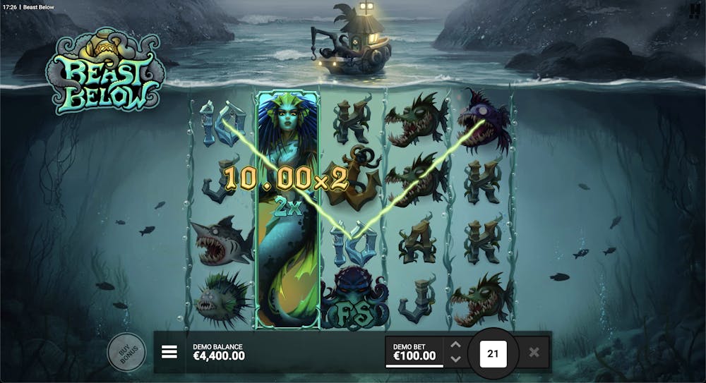 Beast Below slot gameplay showing a winning combination with highlighted paylines and a 2x multiplier, featuring symbols like a mermaid, angler fish, and anchors set against a deep-sea background with a submarine floating above